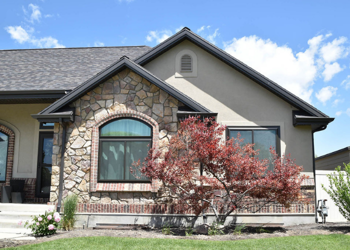 Front of home with picture window and sliding window in Riverton, Utah