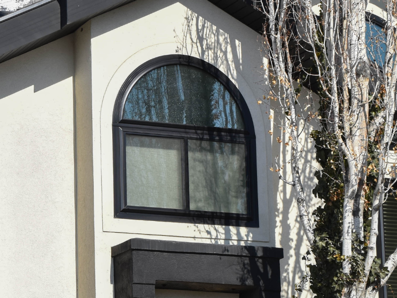 Modern arched window with black frame exterior in Pleasant Grove, Utah