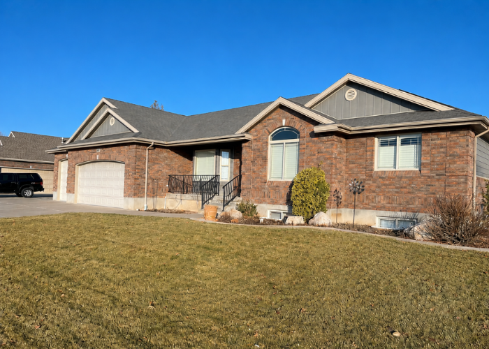 Front side angle showing Ageless Slate siding and brick detail on Layton Utah home