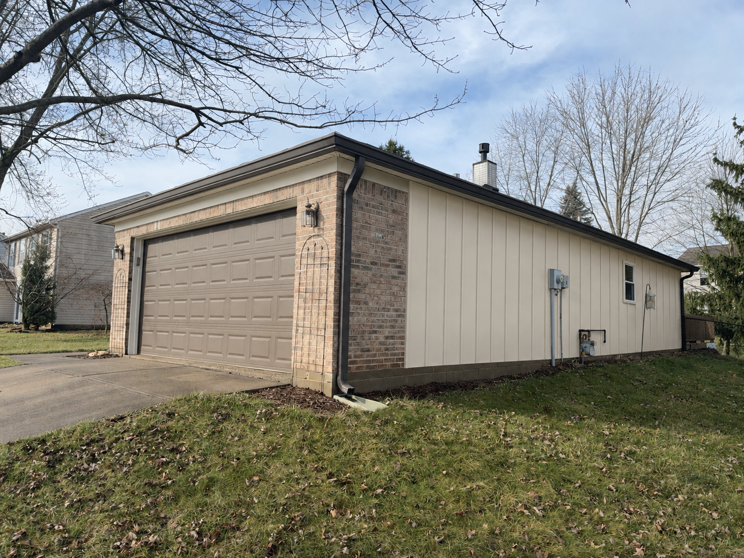 Front side angle after Monterey Sand Ascend Board and Batten siding replacement in Fishers, Indiana