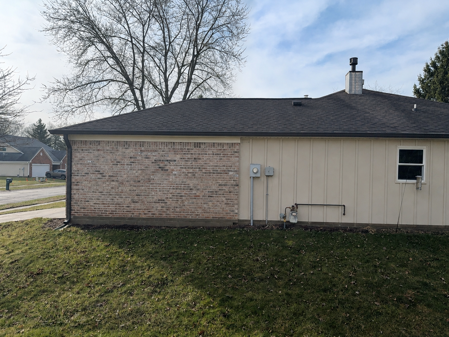 Side of Fishers, Indiana home after Monterey Sand Ascend Board and Batten siding replacement